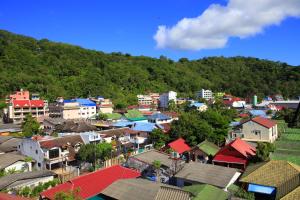 an aerial view of a town with houses and trees at Buasri By Ohm in Patong Beach