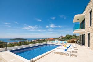 a villa with a swimming pool with a view at Sun Resort Apartments in Zečevo Rogozničko
