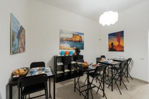 a dining room with chairs and tables with food on them at L'Orto del Conte in Naples +30 photos