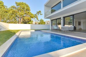 a swimming pool in the backyard of a house at Moradia Sussurros do Mar in Nazaré