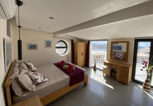 a bedroom with a bed and a tv in it at Villa Kirmizi Lale, Private Pool, Gardens, Very Close to Town - No Need for Taxi in Kas