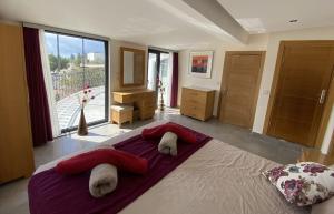 a bedroom with a large bed with red pillows at Villa Kirmizi Lale, Private Pool, Gardens, Very Close to Town - No Need for Taxi in Kas +39 photos
