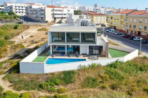 a house on a hill with a swimming pool at Moradia Sussurros do Mar in Nazaré