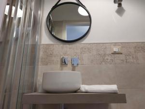a bathroom with a sink and a mirror at Hotel San Domingo in Lido di Camaiore
