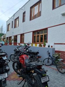a group of motorcycles parked in front of a building at The Mir Villa Ladakh in Leh