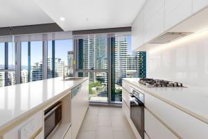 a kitchen with a view of a city skyline at ULTIQA Signature at Broadbeach in Gold Coast