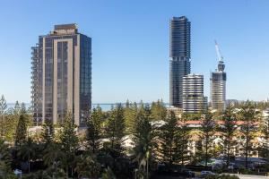 a city skyline with tall buildings and palm trees at ULTIQA Signature at Broadbeach in Gold Coast