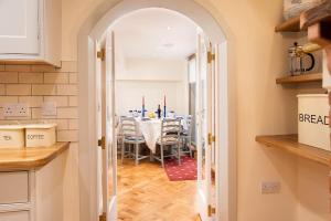 a kitchen and dining room with a table and chairs at The Craftsman's Cottage in Alnwick