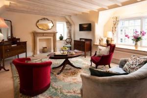 a living room with a couch and chairs and a table at The Craftsman's Cottage in Alnwick