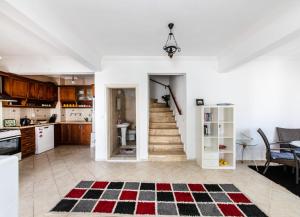 a kitchen and dining room with a staircase in a house at Sea View Duplex Private Villa in Bodrum Gundogan in Gundogan