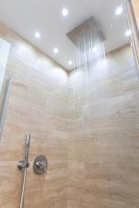 a bathroom with a shower with a shower head at La Rose du Prevot in Fenis