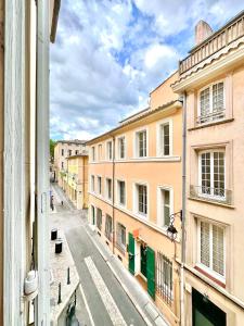 a view from a window of a street with buildings at Èrsextius ABB Aix-en-Provence in Aix-en-Provence