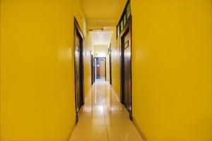 an empty hallway with a yellow wall and a corridorngthngthngthngthngthngth at FabExpress Casa Paradiso, Panaji in Goa