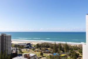 a view of a beach with a building and the ocean at ULTIQA Signature at Broadbeach in Gold Coast