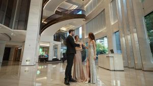 a man and a woman standing in a building at Kingdom Hotel in Yiwu