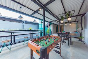a room with a foosball table on a balcony at Ultima Guest House in Bandung