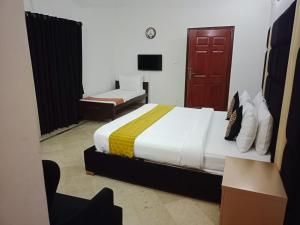 מיטה או מיטות בחדר ב-Capri Residency