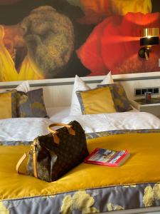 a purse and a book on a bed at Hotel Alte Posthalterei in Creuzburg