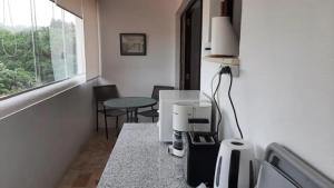 a room with a coffee machine on a counter at Alto da Praia Villa in Colares