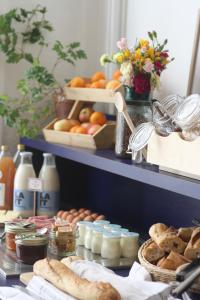 a table with bread and eggs and other food items at SLO Hostel Lyon les Pentes in Lyon