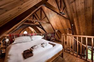 a bedroom with a large bed in a attic at The Tabernacle in Aberfeldy