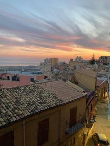 a view of a city at sunset with roofs at DAREB HOME vista mare in Agrigento