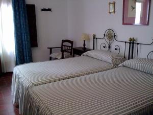 Postel nebo postele na pokoji v ubytování Hostal Gran Capitan