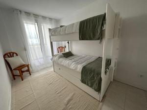 Un dormitorio con dos literas y una silla. en El apartamento de Lola, en Mogro 30 fotos más