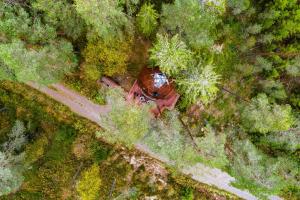 an overhead view of a tractor in the middle of a forest at Treehouse dome in Vidnes