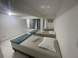 a bedroom with two beds and a window at THE BROTHERS in Angra dos Reis