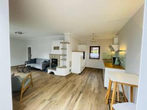 a living room with a couch and a table and a kitchen at Ferienoase Eisvogel in Malchin
