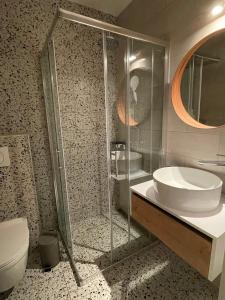 a bathroom with a shower and a sink and a toilet at Mediterra 1 in Crikvenica