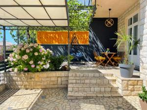 a patio with a bunch of flowers and plants at Mediterra 1 in Crikvenica