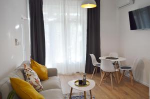 a living room with a couch and a table at Mediterra 1 in Crikvenica +3 photos