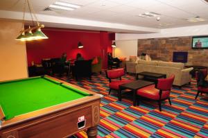 
a living room filled with furniture and a red carpet at Savoy Hostel Galway City Centre in Galway
