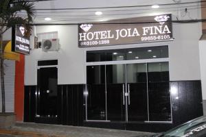 a hotel jola fina with a sign on a building at Hotel Joia Fina in Aparecida