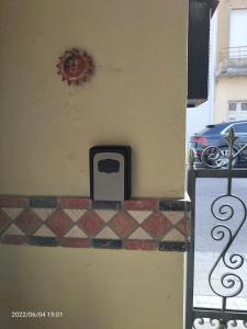 a wall with a cell phone on the side of a building at Casa vacanze Antonella in Oristano