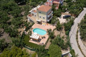 an aerial view of a house with a swimming pool at Villa Melody Complex in Akrotiri