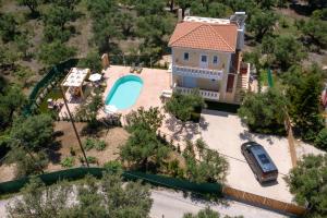 an aerial view of a house with a swimming pool at Villa Melody Complex in Akrotiri