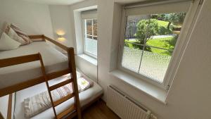 a small room with a bunk bed and a window at Apartments FEICHTNER Manfred -Tulfes - Innsbruck-Land - Tirol in Tulfes