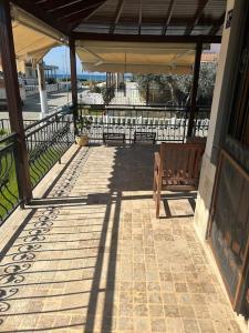 a patio with a bench and a view of the water at 2 minute walk to seaside in Kuşadası