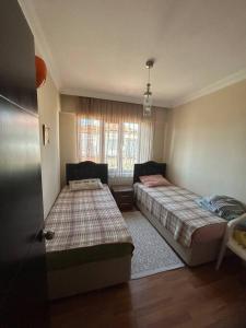 a bedroom with two beds and a window at 2 minute walk to seaside in Kuşadası