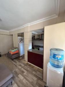a room with a kitchen with a refrigerator and a counter at 2 minute walk to seaside in Kuşadası