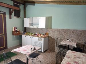 a kitchen with two tables and a counter with chairs at Emirhan Guesthouse & Suites in Istanbul