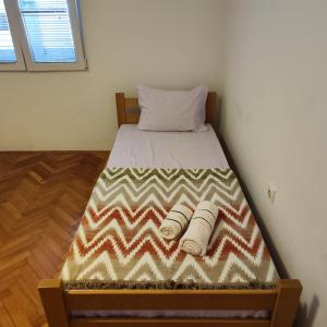 a bed in a room with two rolled up towels on it at Real Apartments in Budva