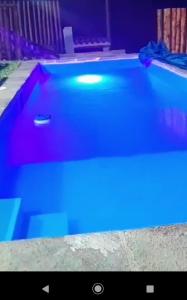a swimming pool with blue lights in a room at Casa en cineguilla in Cieneguilla