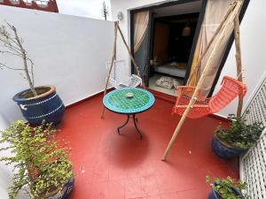 a patio with a table and chairs on a porch at Riad 7 Pierres in Essaouira