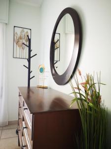 a mirror sitting on top of a dresser in a room at Sea&Sun Glyfada Apartment in Athens