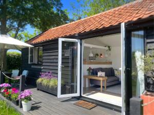 a garden room with a sliding glass door at The Little Barn in Hoxne