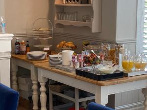 a table with food and drinks on top of it at Camelot Guest House in Falmouth +18 photos